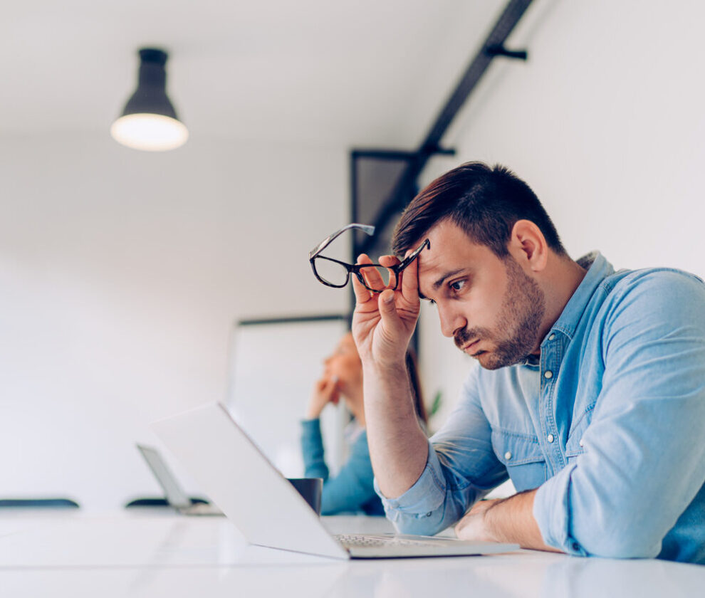 Exhausted young businessman at work