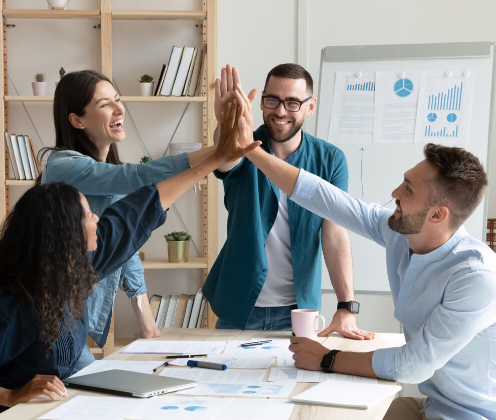 Overjoyed,Diverse,Businesspeople,Gather,In,Office,Gave,High,Five,Celebrate