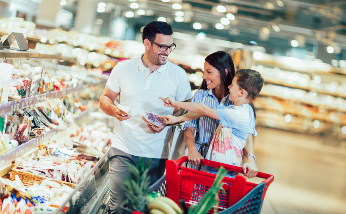 Happy,Family,With,Child,And,Shopping,Cart,Buying,Food,At