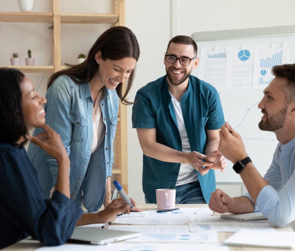 Smiling,Diverse,Colleagues,Gather,In,Boardroom,Brainstorm,Discuss,Financial,Statistics