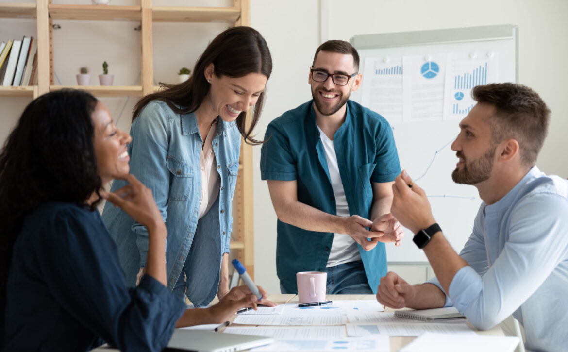 Smiling,Diverse,Colleagues,Gather,In,Boardroom,Brainstorm,Discuss,Financial,Statistics